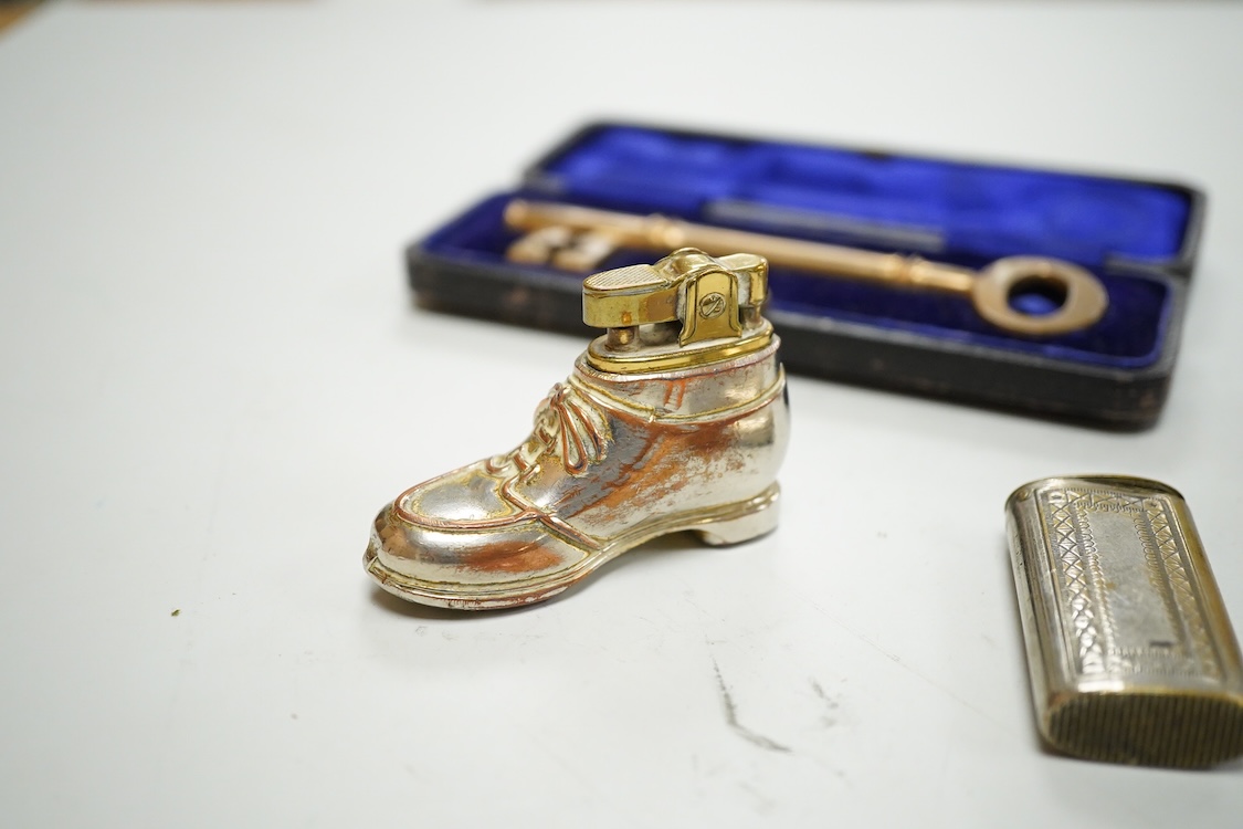 A collection of sundry items to include a large cased key, novelty lighter in the form of a shoe and a citrine set propelling pencil